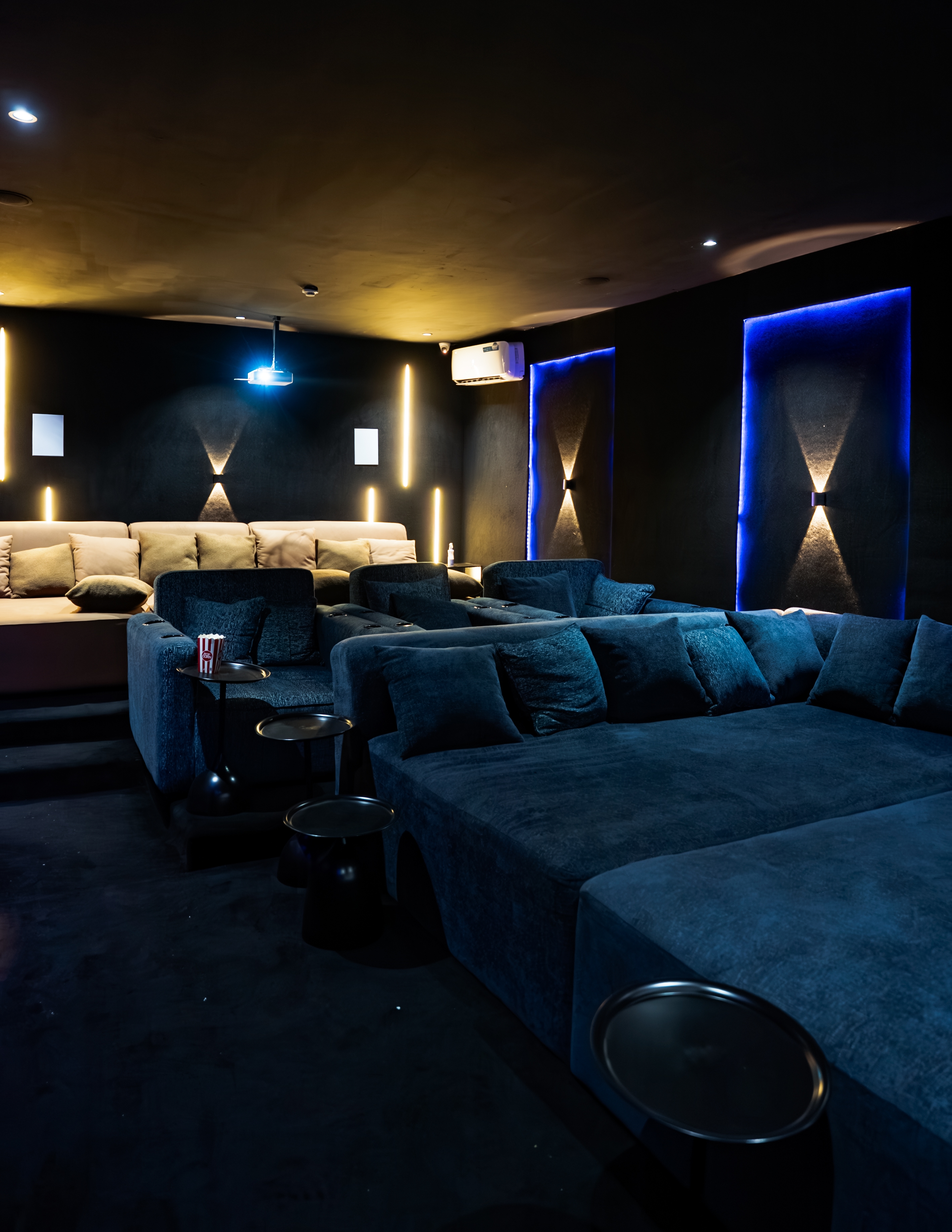 Cinema seating with popcorn and the screen lit up